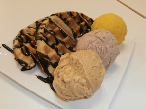Waffles with cendal, hazelnut and mango ice cream and chocolate fudge sauce